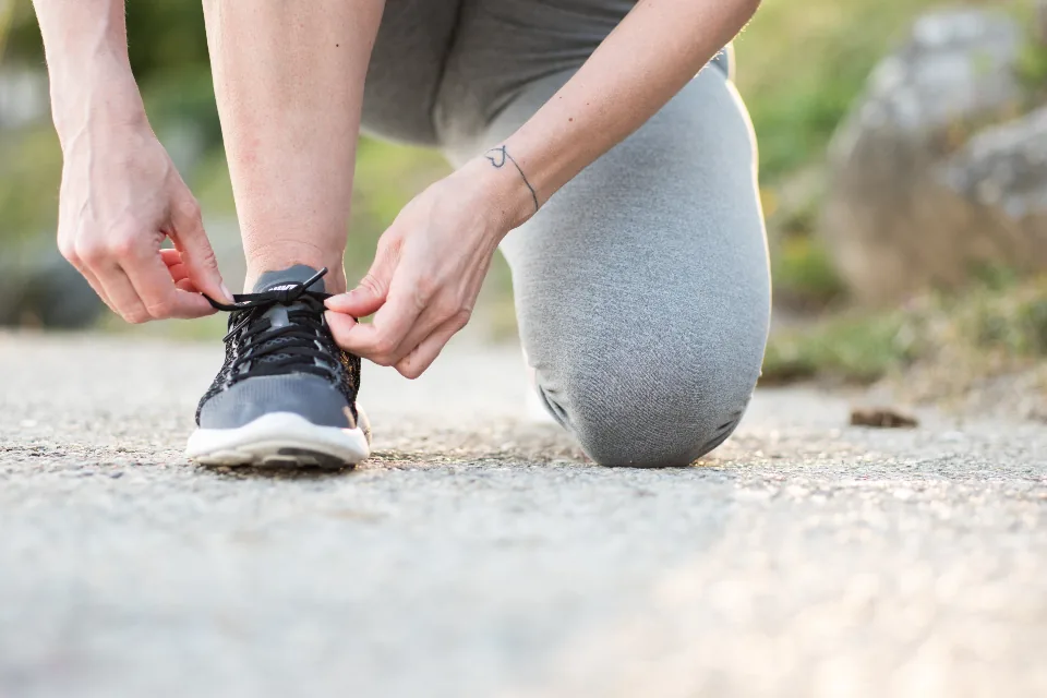 Tying a running shoe before a walk